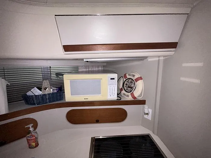 Slide: The Image of Interior of 1990 Carver 3257 Montego with microwave, life preserver, and kitchen area. - 26