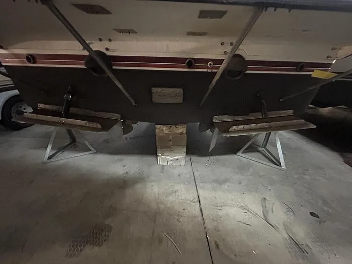 Slide: The Image of Rear view of a 1990 Carver 3257 Montego boat on stands in a garage. - 3
