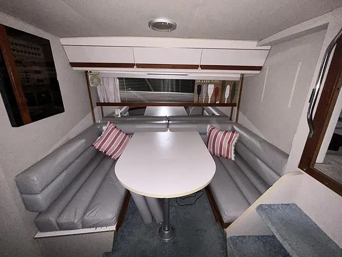Slide: The Image of Interior of 1990 Carver 3257 MONTEGO with dining area and striped cushions. - 33