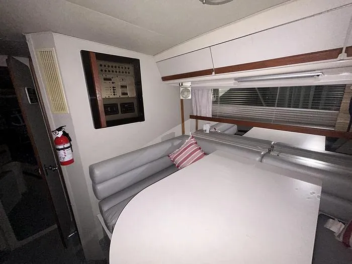 Slide: The Image of Interior of 1990 Carver 3257 MONTEGO boat with dining area and control panel. - 34