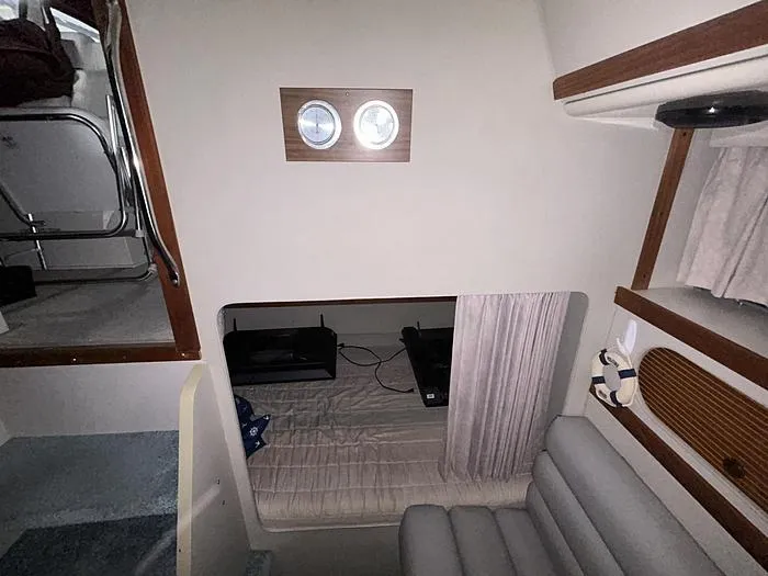 Slide: The Image of Interior of a 1990 Carver 3257 MONTEGO boat, featuring a cozy cabin space. - 36