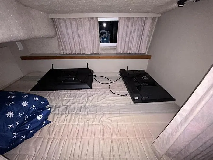 Slide: The Image of 1990 Carver 3257 MONTEGO cabin interior with bed, window, and electronics. - 37