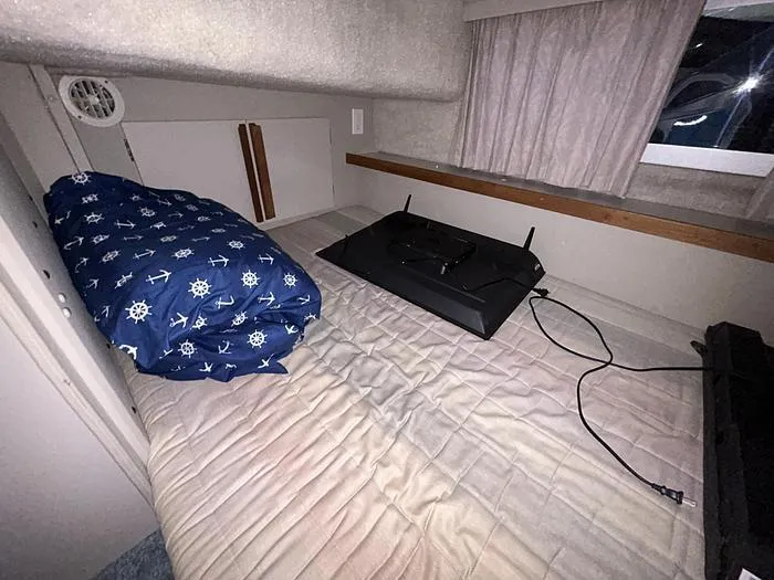 Slide: The Image of Interior cabin of 1990 Carver 3257 Montego with bedding and TV. - 38
