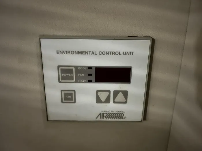 Slide: The Image of Environmental control unit panel on 1990 Carver 3257 MONTEGO boat, featuring power and fan controls. - 39
