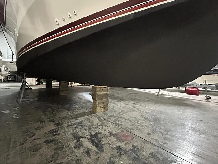 Slide: The Image of 1990 Carver 3257 MONTEGO boat hull on supports in a storage facility. - 5