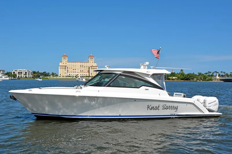 The Image of 2021 Tiara Yachts 38LX boat named "Knot Sorry" on water with scenic background. - 0