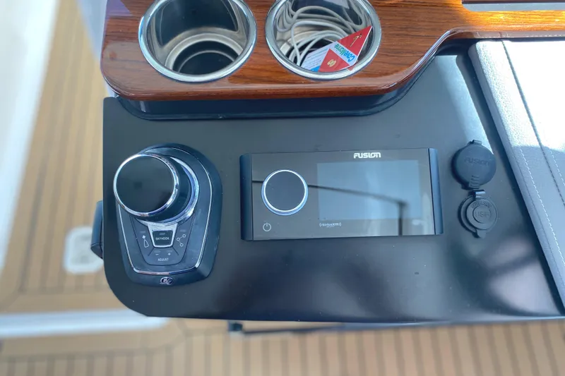 Slide: The Image of Control panel of 2021 Tiara Yachts 38LX with Fusion audio system and cup holders. - 10