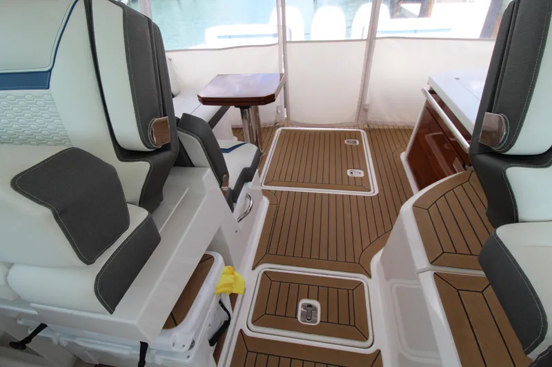 Slide: The Image of Interior of 2021 Tiara Yachts 38LX, featuring luxurious seating and teak flooring. - 12