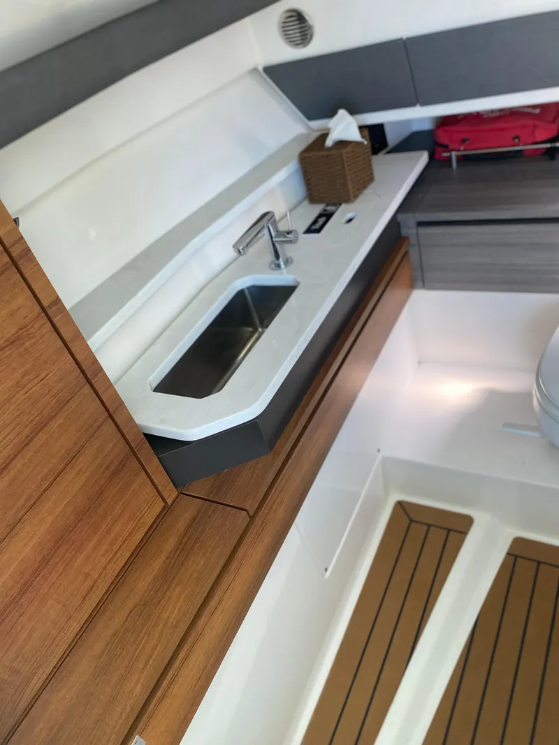 Slide: The Image of Interior of 2021 Tiara Yachts 38LX, featuring a sleek sink and modern cabinetry. - 15