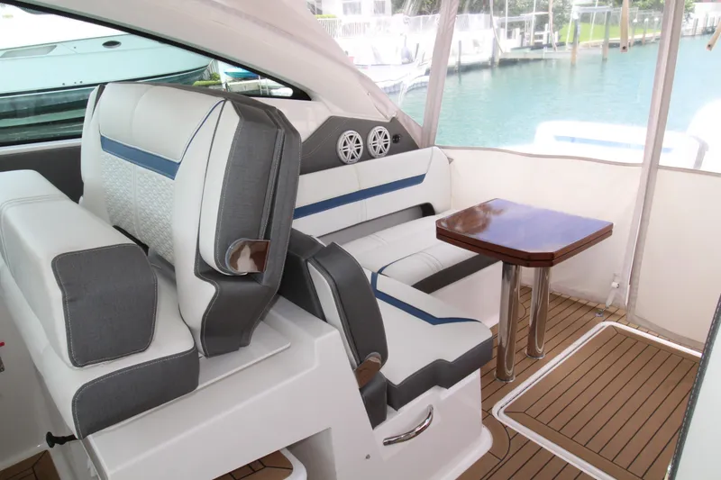 Slide: The Image of Luxurious interior of 2021 Tiara Yachts 38LX with elegant seating and wooden table. - 19