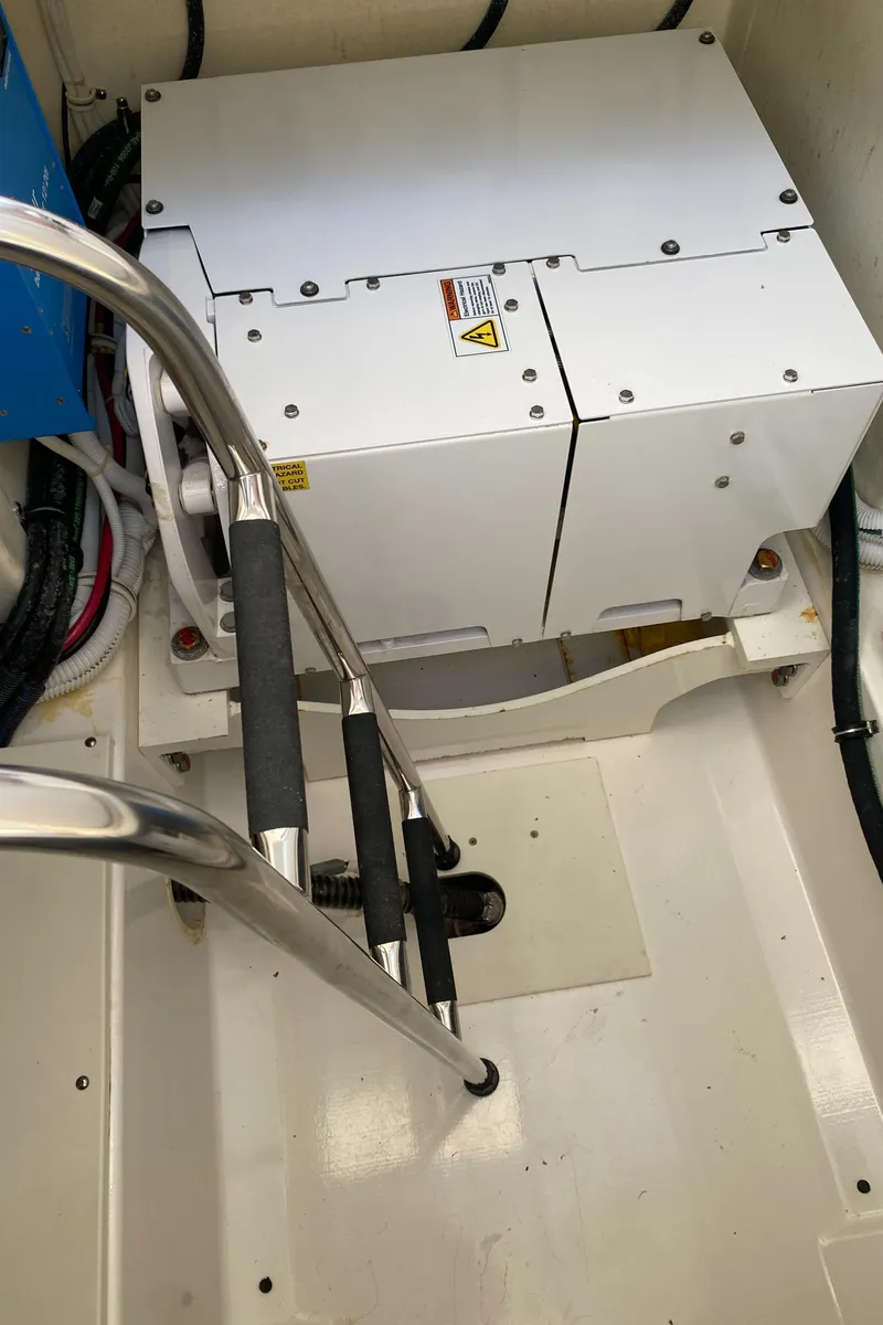 Slide: The Image of Engine compartment of 2021 Tiara Yachts 38LX with visible equipment and ladder. - 25