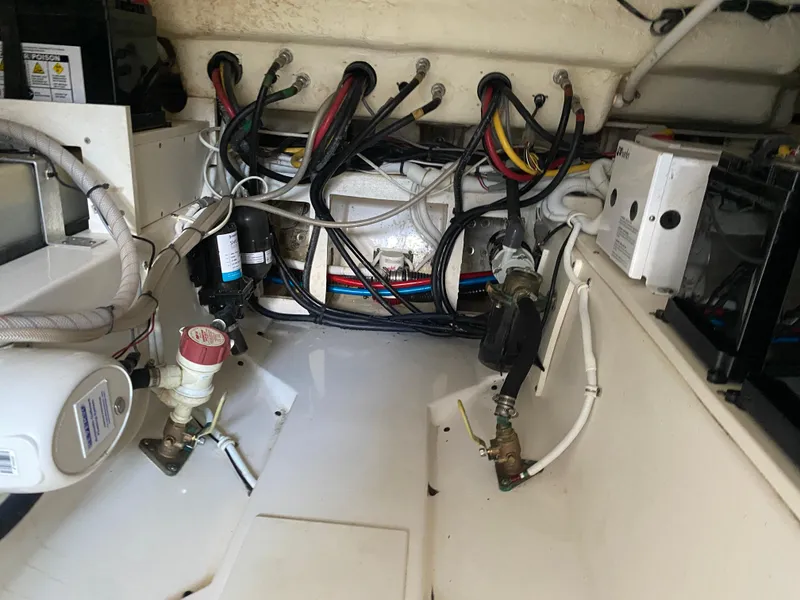 Slide: The Image of Engine compartment of a 2021 Tiara Yachts 38LX, showcasing wiring and mechanical components. - 28