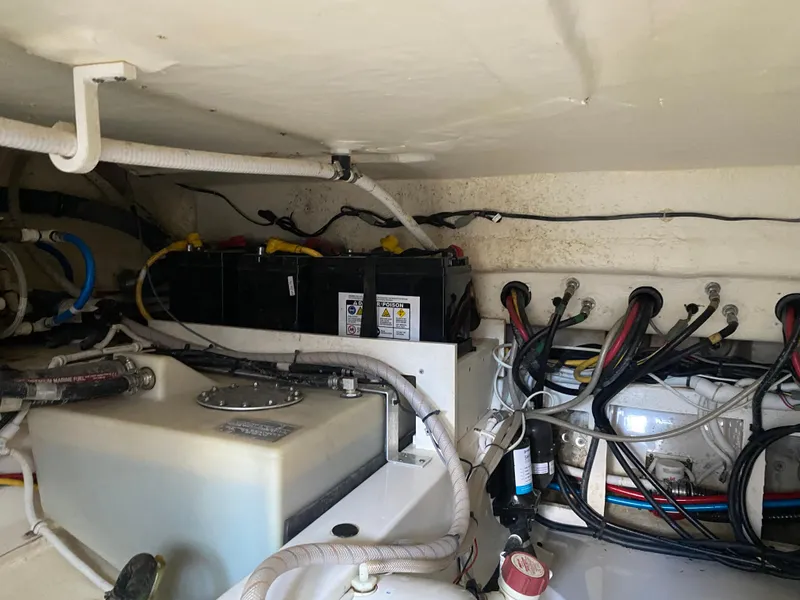 Slide: The Image of Engine compartment of 2021 Tiara Yachts 38LX, showing batteries and wiring. - 29