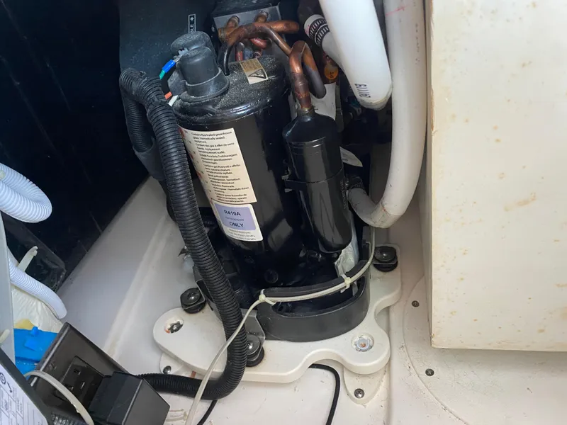 Slide: The Image of Engine compartment of a 2021 Tiara Yachts 38LX, featuring mechanical components and wiring. - 34