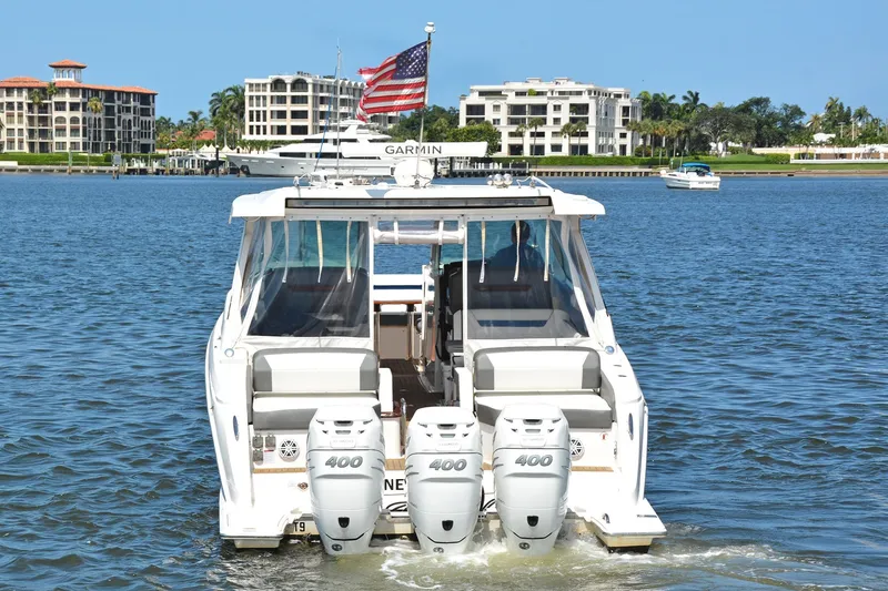 Slide: The Image of 2021 Tiara Yachts 38LX with triple 400 engines on a sunny waterfront. - 5