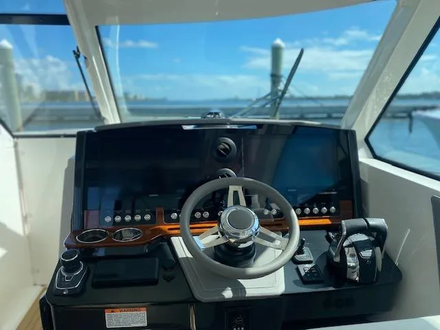 Slide: The Image of Helm of 2021 Tiara Yachts 38LX with modern controls and ocean view. - 6