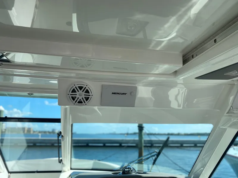 Slide: The Image of 2021 Tiara Yachts 38LX interior with Mercury speaker, ocean view in background. - 9