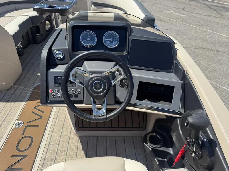 Slide: The Image of 2025 Avalon 2385 25 Catalina QL boat dashboard with steering wheel and controls. - 10