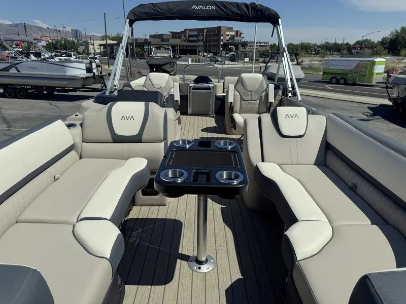 Slide: The Image of 2025 Avalon 2385 25 Catalina QL pontoon boat interior with luxurious seating and table. - 11