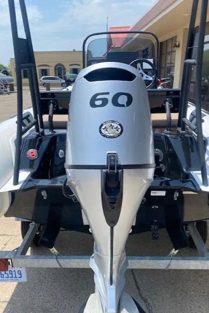 Slide: The Image of 2021 Brig Navigator 485 boat with a 60 HP outboard motor, parked on a trailer. - 3