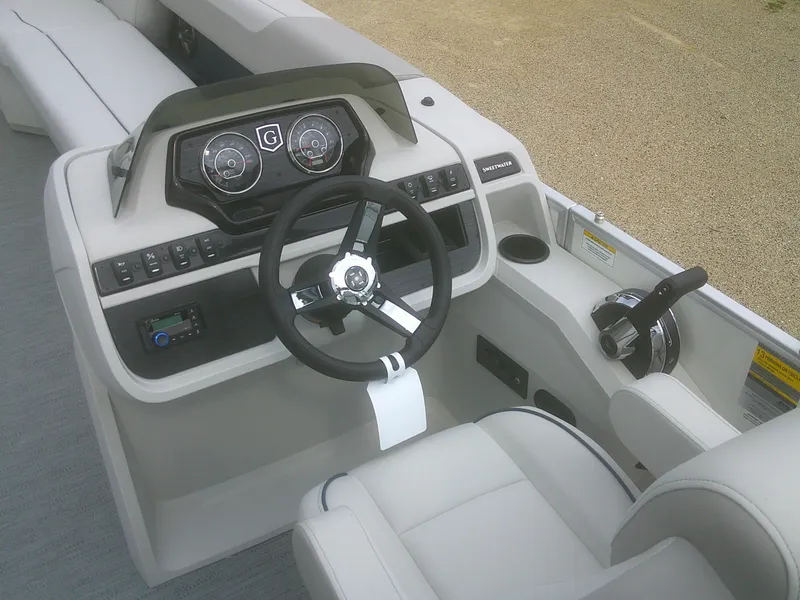 Slide: The Image of 2026 Godfrey 2286 Sweetwater Cruise Special Edition boat dashboard with steering wheel and controls. - 10