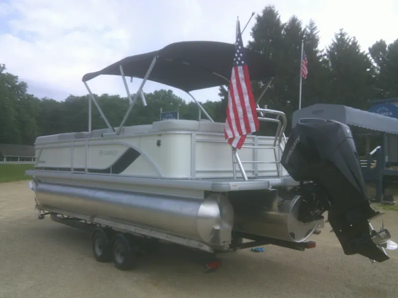 Slide: The Image of 2026 Godfrey 2286 Sweetwater Cruise Special Edition pontoon boat with American flag and canopy. - 16