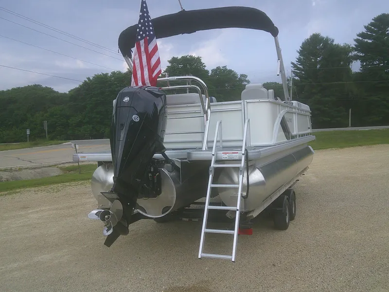 Slide: The Image of 2026 Godfrey 2286 Sweetwater Cruise Special Edition pontoon boat with American flag and outboard motor. - 3