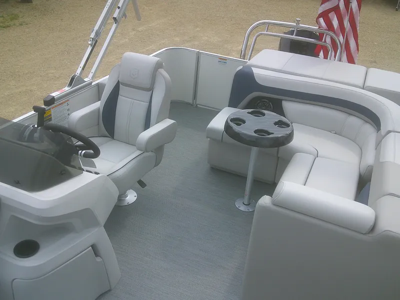 Slide: The Image of 2026 Godfrey 2286 Sweetwater Cruise Special Edition boat interior with seating and steering console. - 9