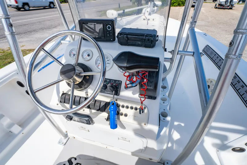 Slide: The Image of 2008 Sea Chaser 170 Bay Runner boat dashboard with steering wheel and navigation equipment. - 15