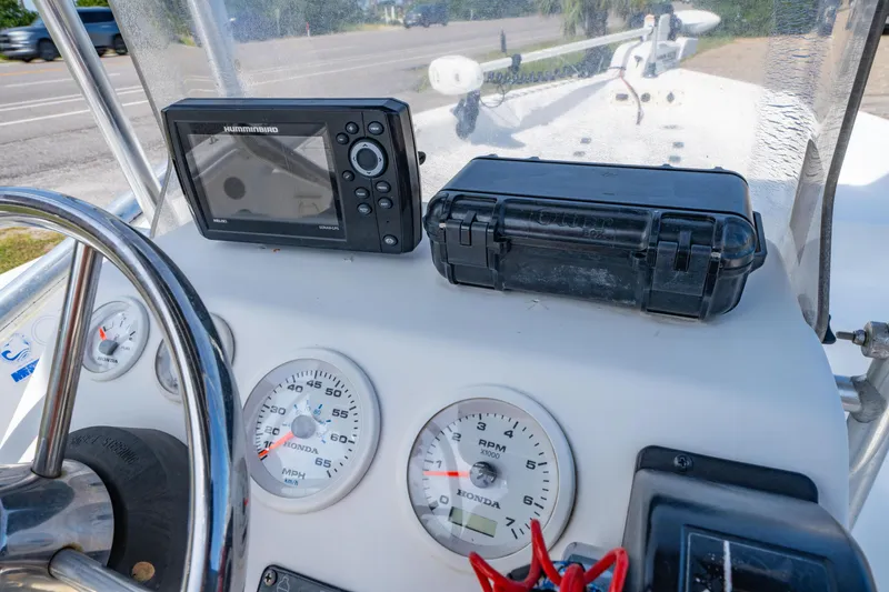 Slide: The Image of Dashboard of a 2008 Sea Chaser 170 Bay Runner with gauges and navigation equipment. - 16