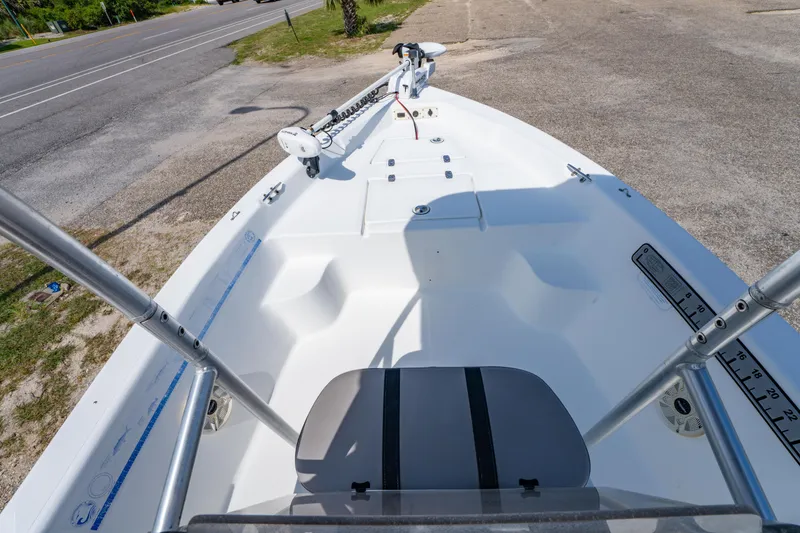 Slide: The Image of 2008 Sea Chaser 170 Bay Runner boat interior with seating and equipment, parked near a road. - 18