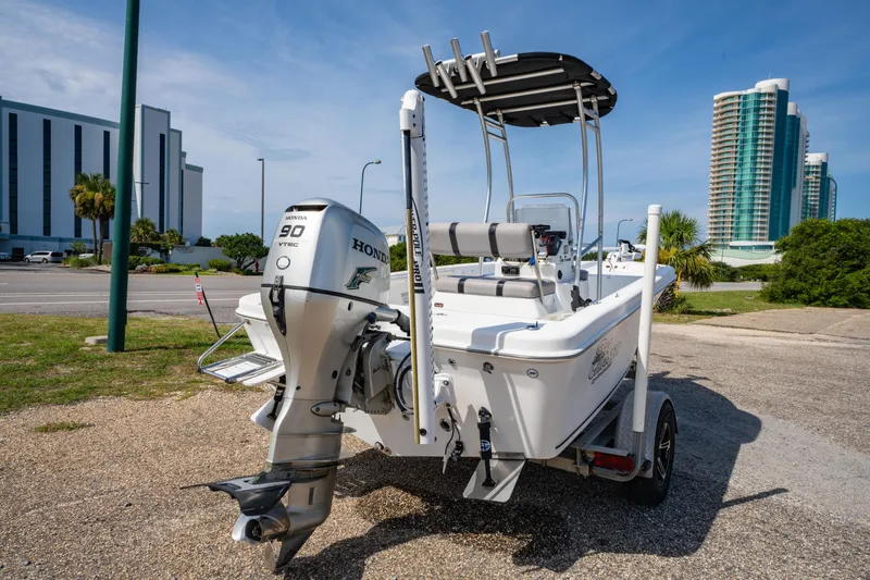 Slide: The Image of 2008 Sea Chaser 170 Bay Runner boat with Honda 90 VTEC engine, parked near modern buildings. - 3