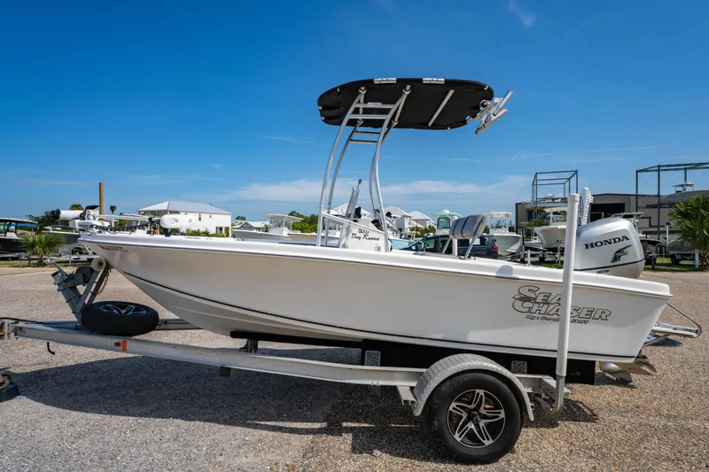 Slide: The Image of 2008 Sea Chaser 170 Bay Runner boat on trailer, parked outdoors under clear blue sky. - 6