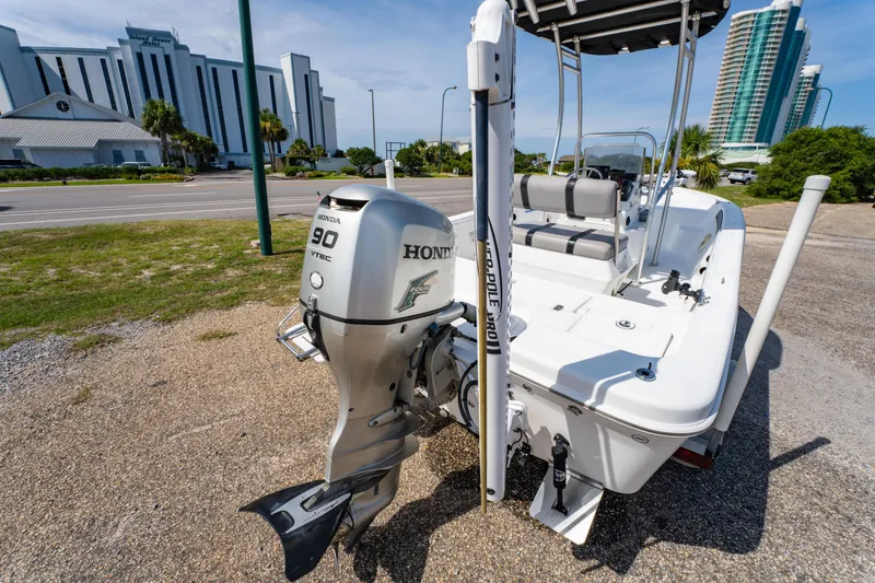 Slide: The Image of 2008 Sea Chaser 170 Bay Runner with Honda 90 VTEC engine, parked near modern buildings. - 9