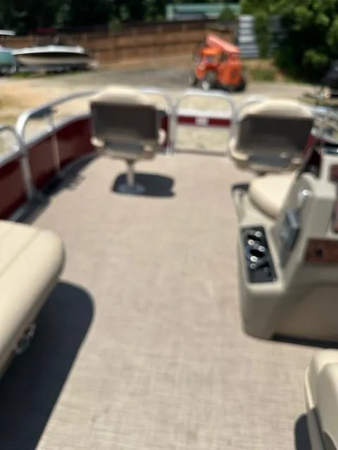 Slide: The Image of 2024 Sun Tracker Bass Buggy 16 XL Select pontoon boat interior with seating and controls. - 12