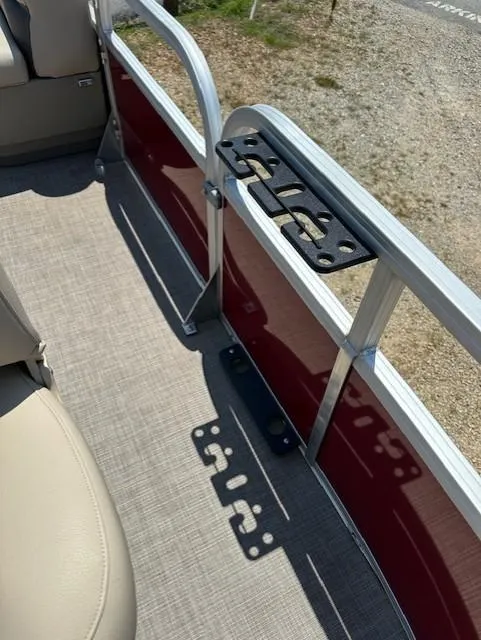 Slide: The Image of 2024 Sun Tracker Bass Buggy 16 XL Select interior with beige seating and red paneling. - 13