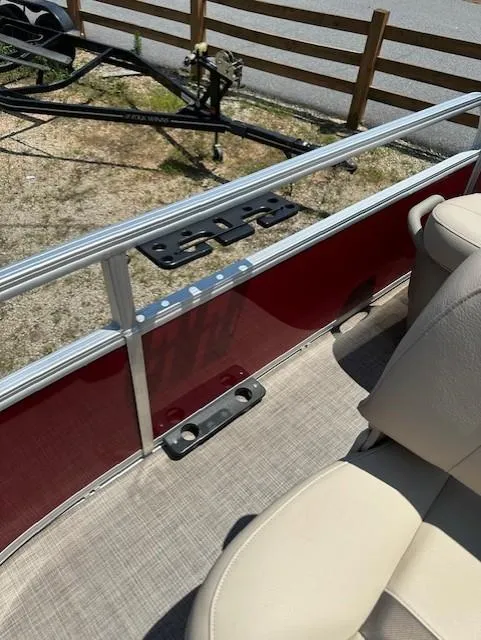Slide: The Image of 2024 Sun Tracker Bass Buggy 16 XL Select interior with beige seating and red paneling. - 14