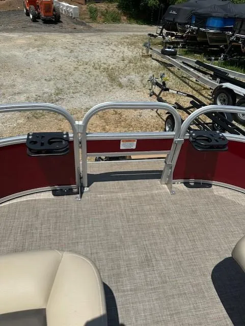 Slide: The Image of 2024 Sun Tracker Bass Buggy 16 XL Select pontoon boat interior with beige seating and red railing. - 15