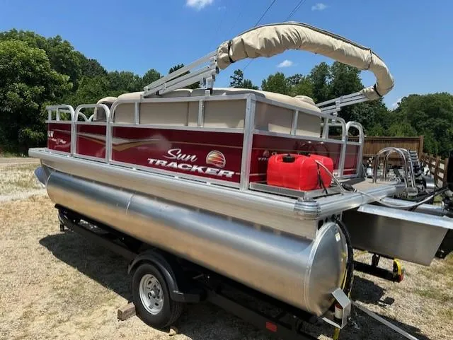 Slide: The Image of 2024 Sun Tracker Bass Buggy 16 XL Select pontoon boat on trailer, outdoors. - 5