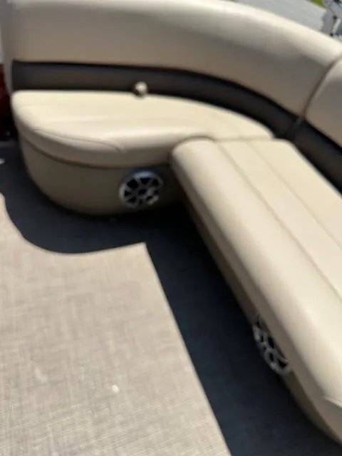 Slide: The Image of 2024 Sun Tracker Bass Buggy 16 XL Select boat interior with beige seating and speaker. - 9