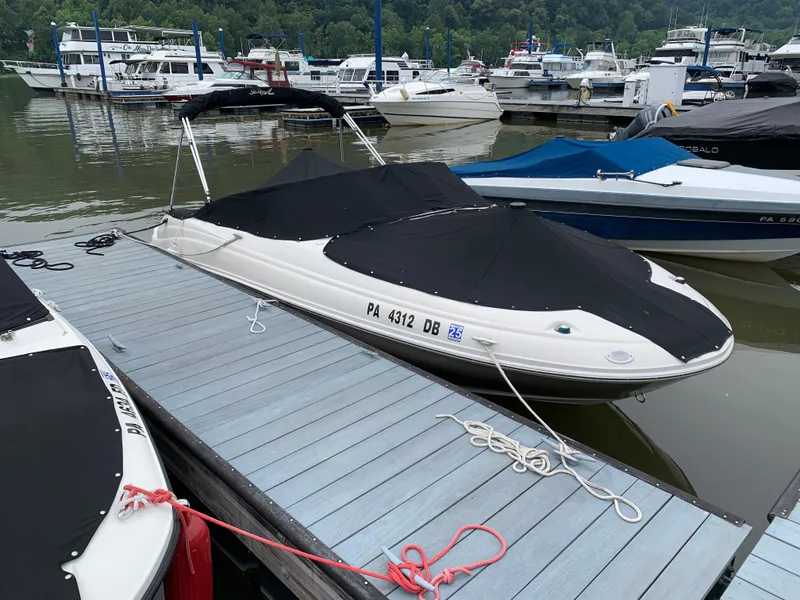 Slide: The Image of 2008 Sea Ray 200 Sundeck boat docked with black cover at marina. - 10