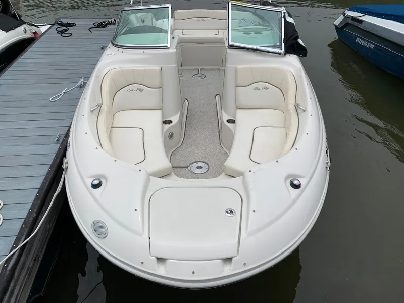 Slide: The Image of 2008 Sea Ray 200 Sundeck boat docked, featuring spacious seating and open deck design. - 3