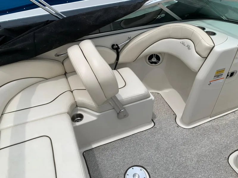 Slide: The Image of 2008 Sea Ray 200 Sundeck interior with beige seating and carpeted flooring. - 4
