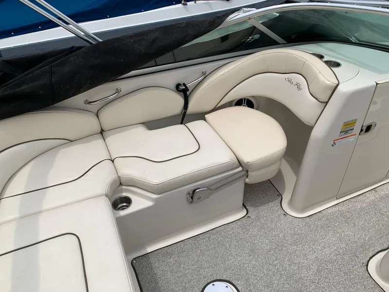 Slide: The Image of 2008 Sea Ray 200 Sundeck interior with beige seating and cup holders. - 5
