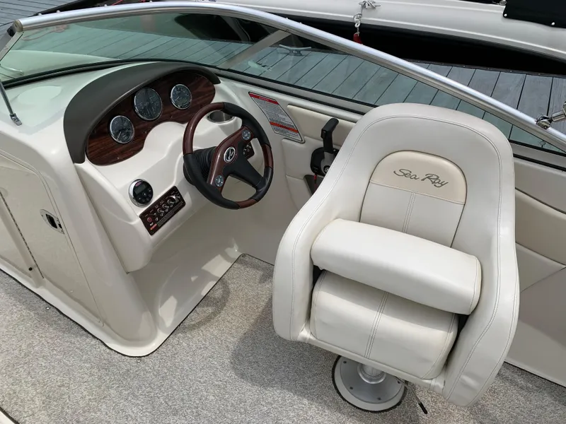 Slide: The Image of 2008 Sea Ray 200 Sundeck boat interior with steering wheel and captain's chair. - 6