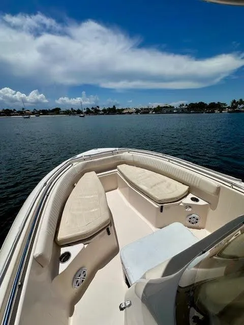 Slide: The Image of 2012 Grady-White Fisherman 230 boat on calm water under a blue sky. - 11