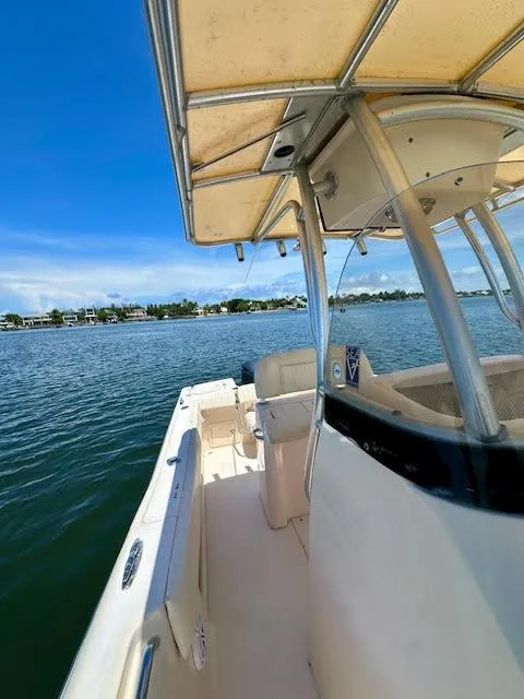 Slide: The Image of 2012 Grady-White Fisherman 230 boat on calm water under clear blue sky. - 13