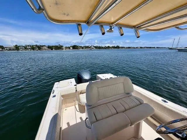 Slide: The Image of 2012 Grady-White Fisherman 230 boat on calm water, under a sunny sky. - 14