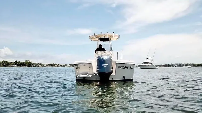 Slide: The Image of 2012 Grady-White Fisherman 230 boat on calm water, clear sky background. - 2