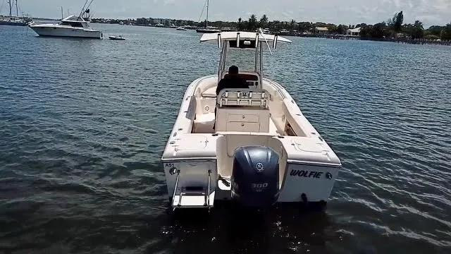 Slide: The Image of 2012 Grady-White Fisherman 230 boat on calm water, rear view with outboard motor. - 6
